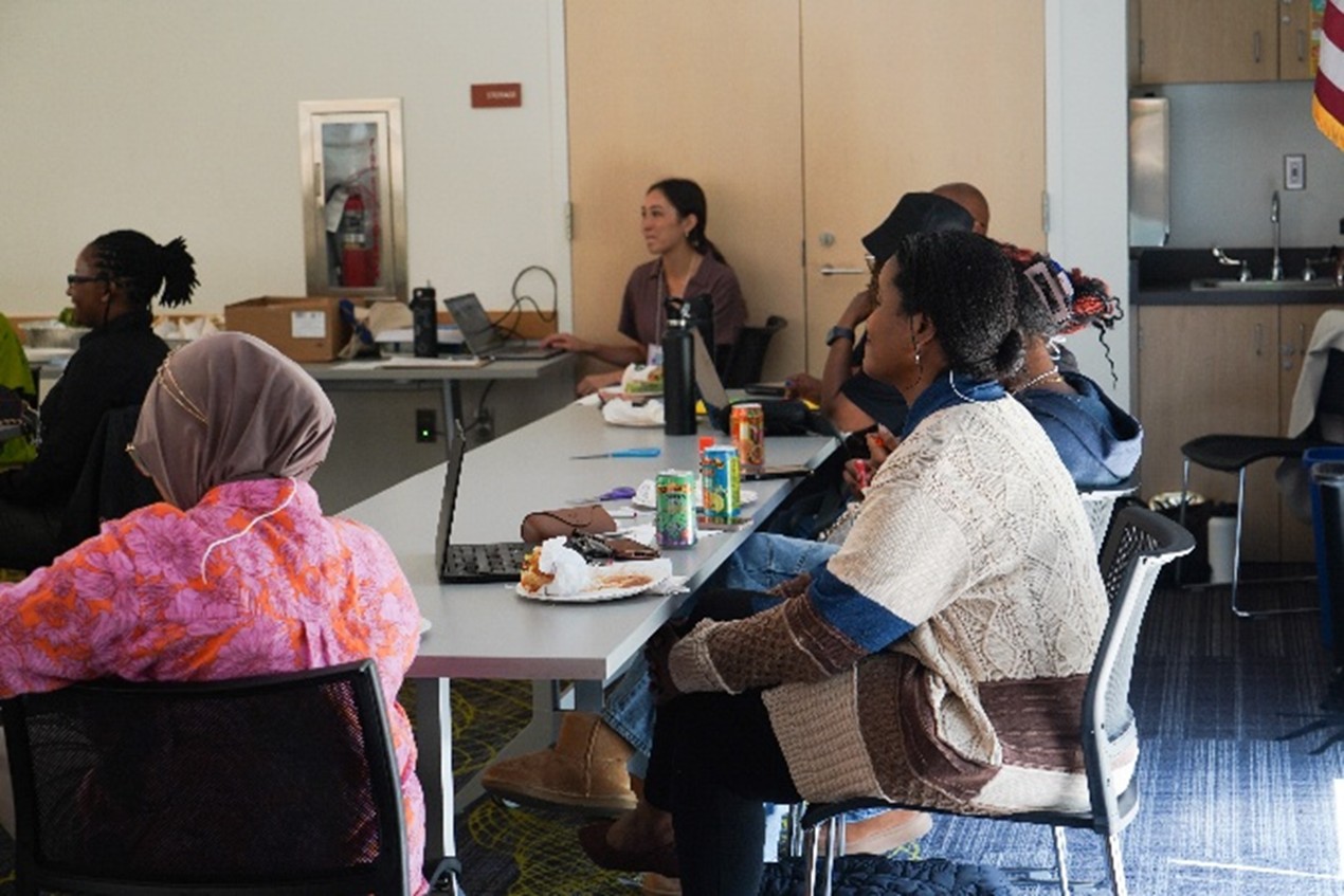 several people listen to a presentation 