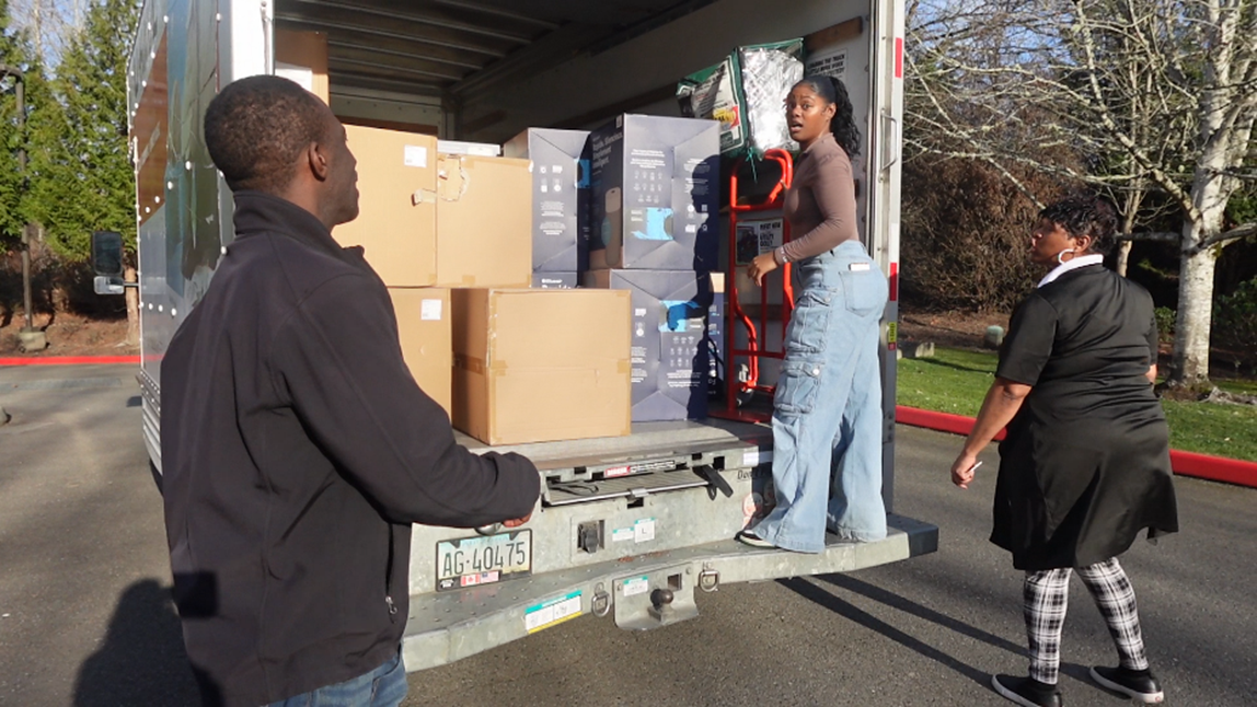people unload air purifiers from a truck