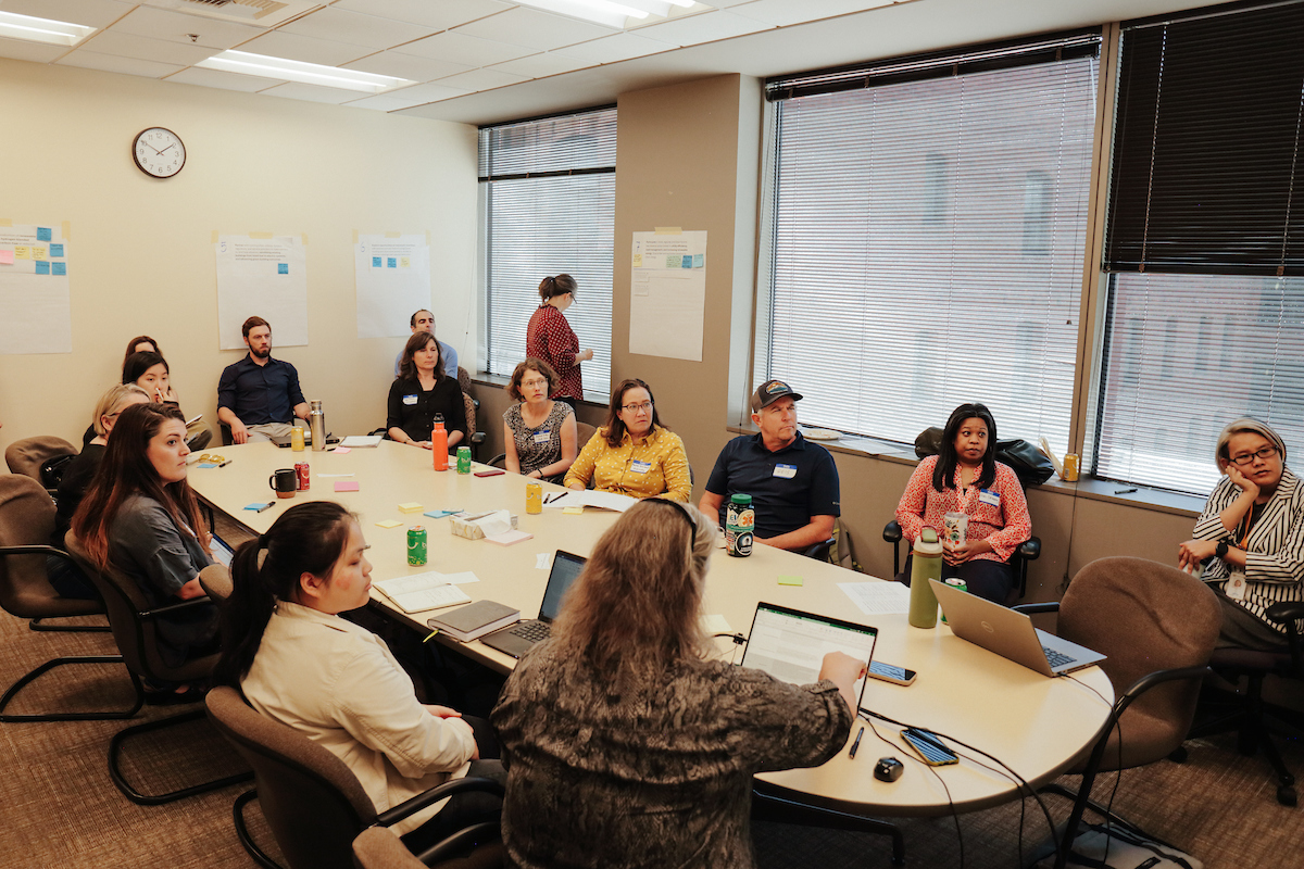 group of people seated around a table 