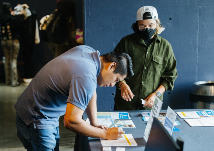 King County JumpStart coordinator hosts sign-up table for potential participants and contractors.
