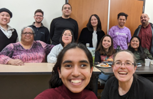 large group of people smiling and posing for photo