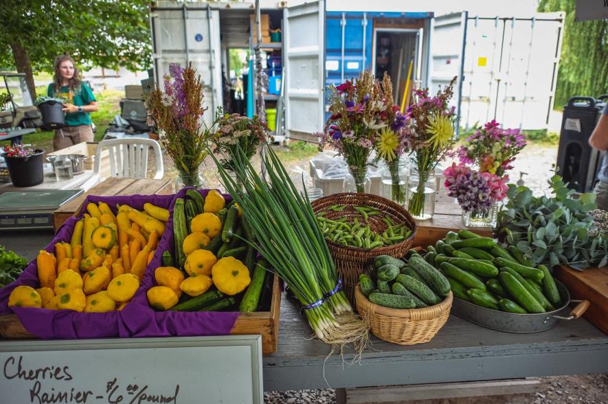 Bushels of farm produce on a table. 