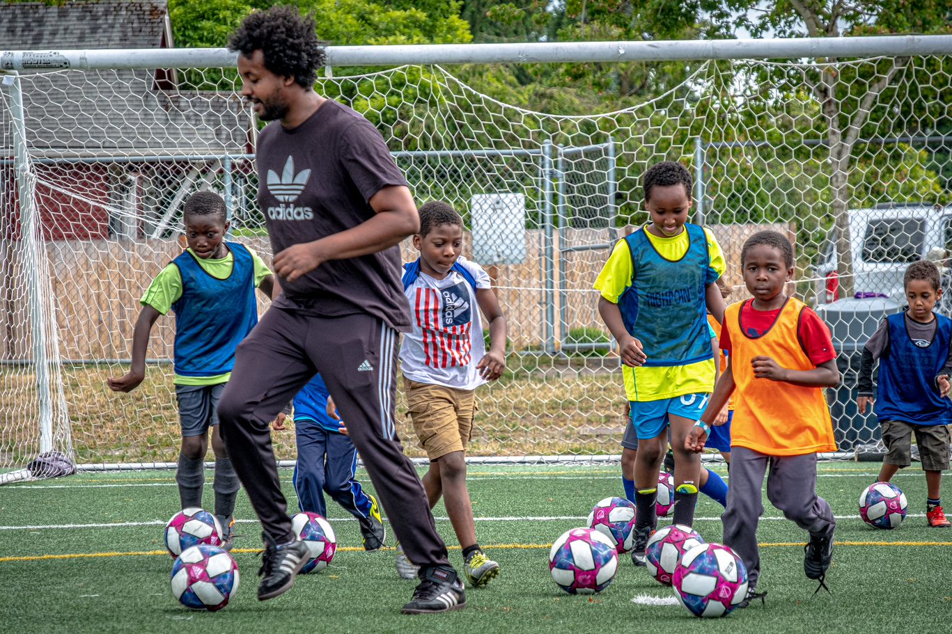 Boys and their coach playing soccer