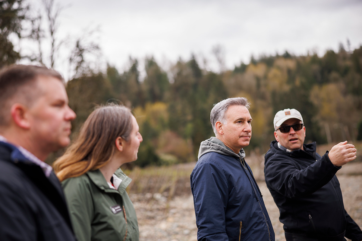 Executive Constantine is briefed by experts along Cedar River