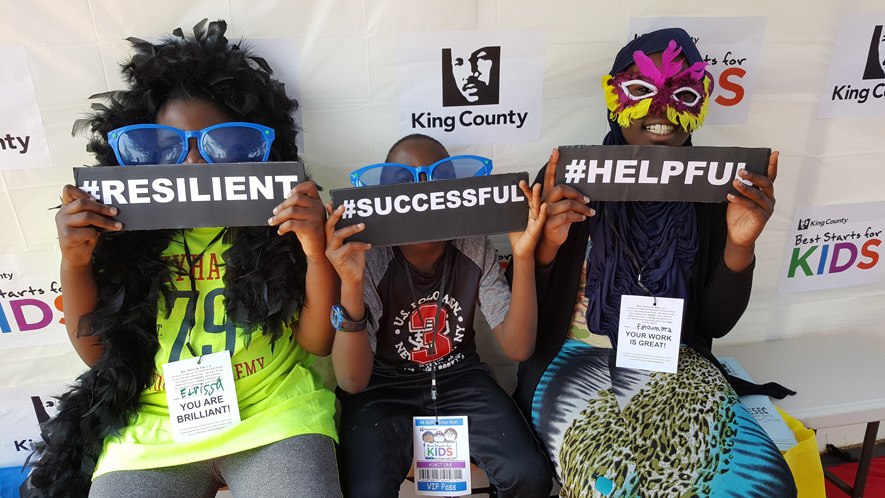 Children holding signs saying resilient, successful and helpful