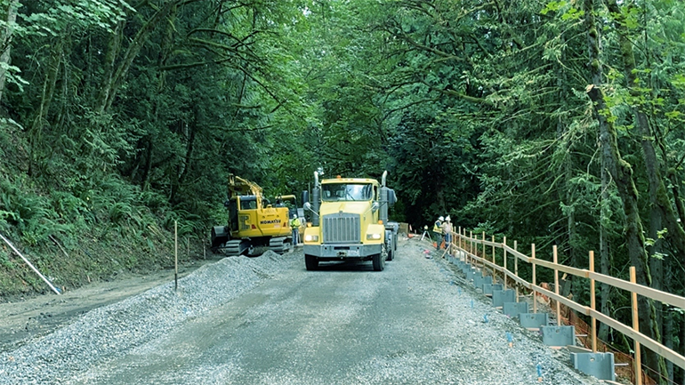 Crews are grading the new road in preparation for paving. 