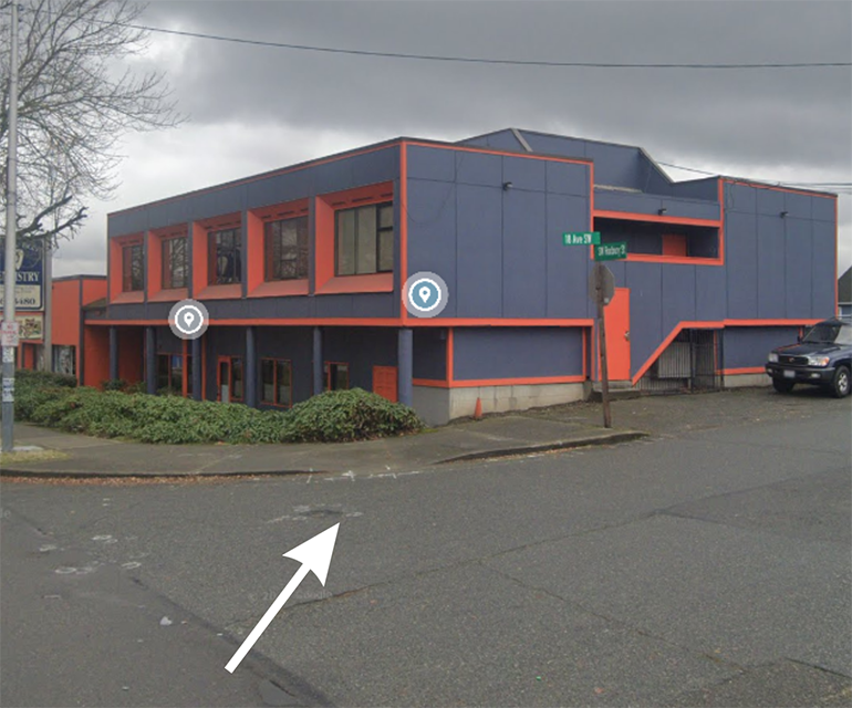 Picture of the existing curb ramp at SW Roxbury St and 18th Ave SW.