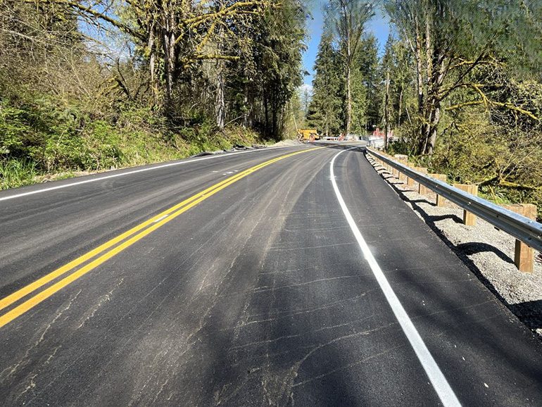 New pavement, lane markings and guardrail are now complete on Ames Lake-Carnation Rd NE approaching the north and south ends of the bridge.