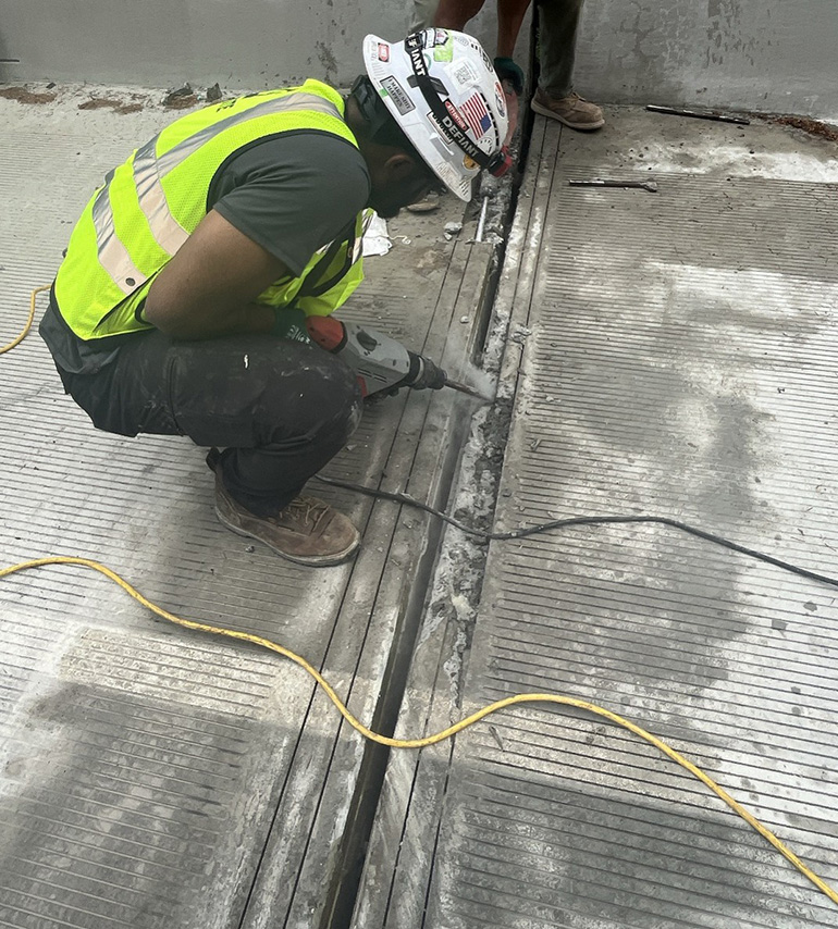 Crews saw away concrete to access the expansion joint. 