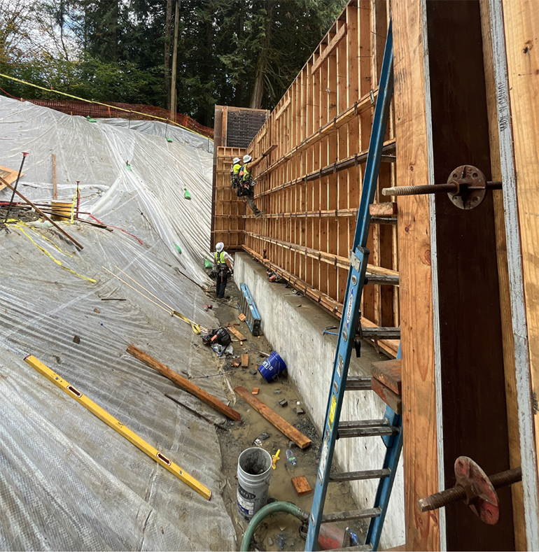 Crews build wood formwork on the north abutment wall. 