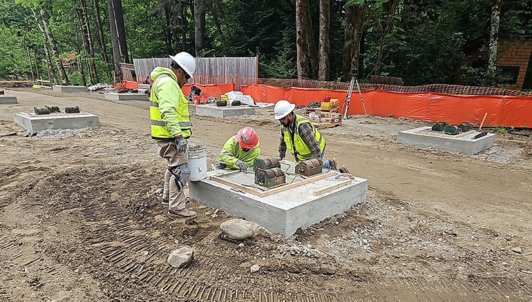 3 crew members working on concrete slab