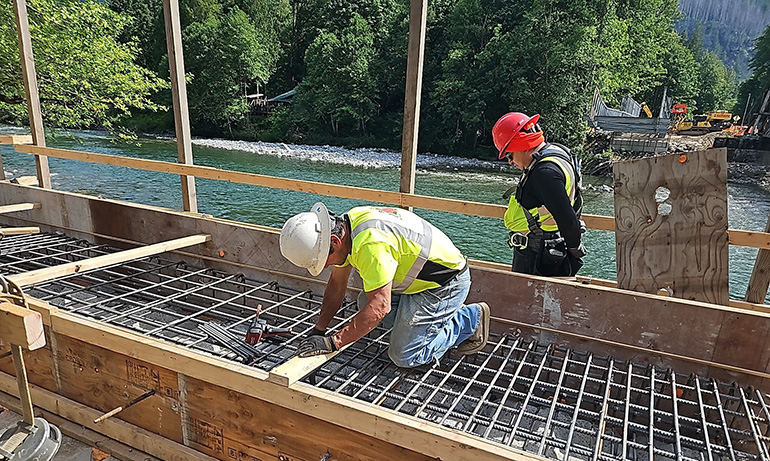 Crew members working on bridge wall