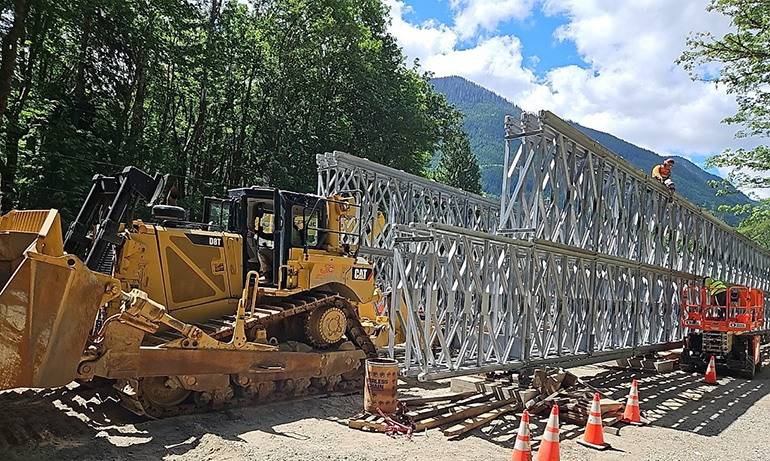Heavy machinery next to bridge
