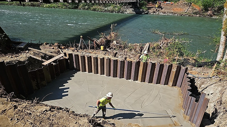 Maintenance crew member spreading concrete