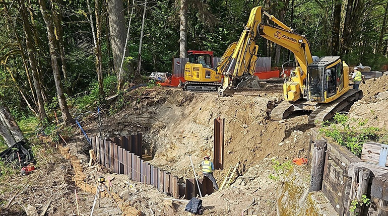 Sheet piles being installed on hillside