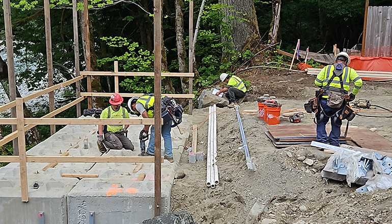 Maintenance workers installing sheet piles