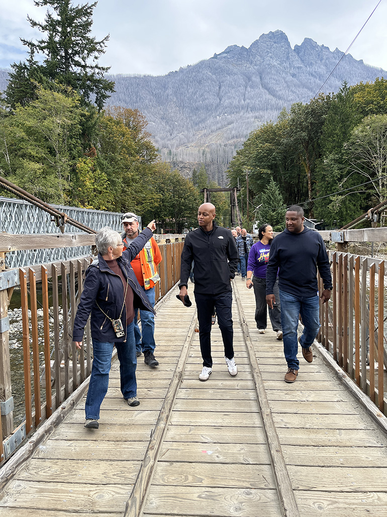 People walking across timber bridge