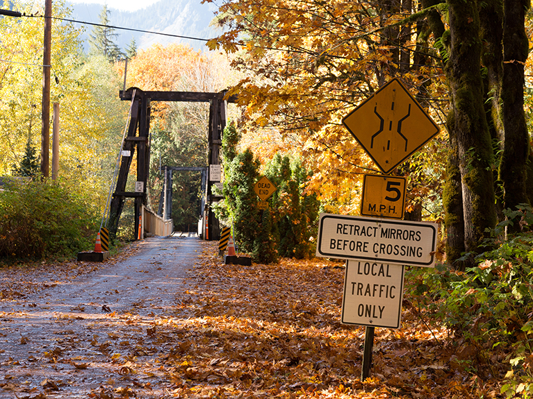 Signage before the bridge, facing west