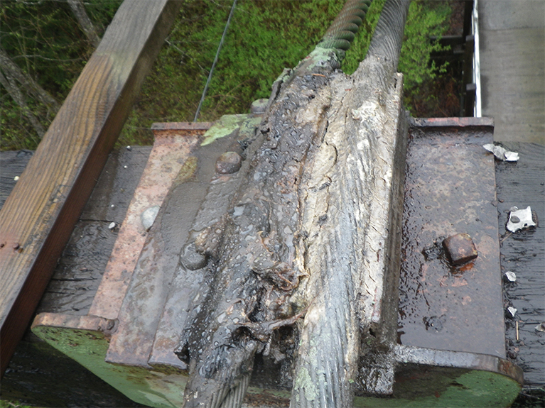 Rusted cables at the top of the bridge tower
