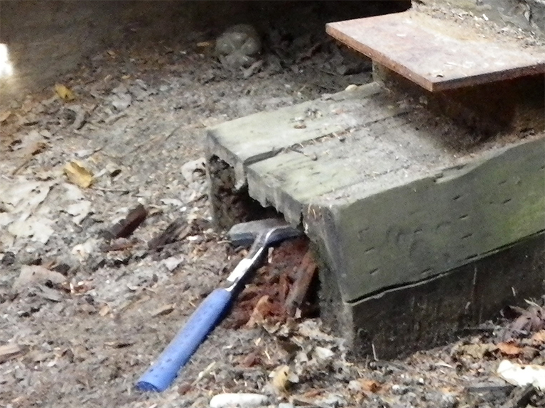 Crushed timber support under a bridge cap
