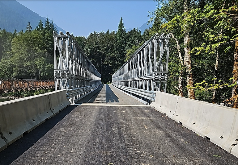 Concrete road leading onto temportary bridge