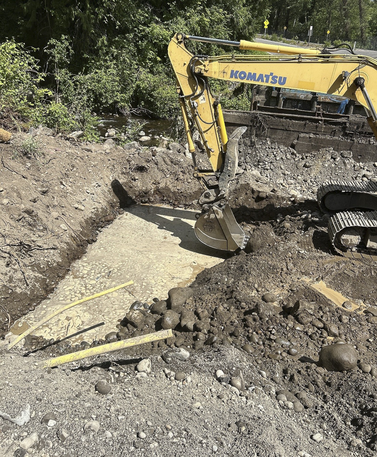 Excavator digging ditch