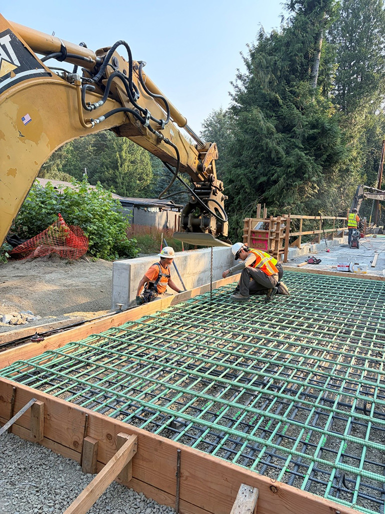 Crew member on rebar about to pour concrete