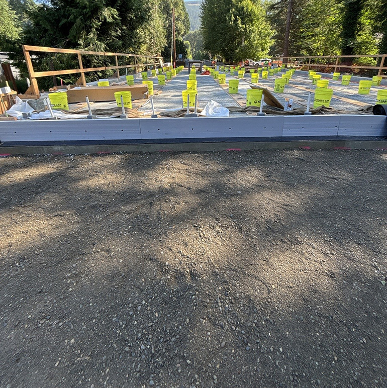 Gravel road with new concrete drainage system.