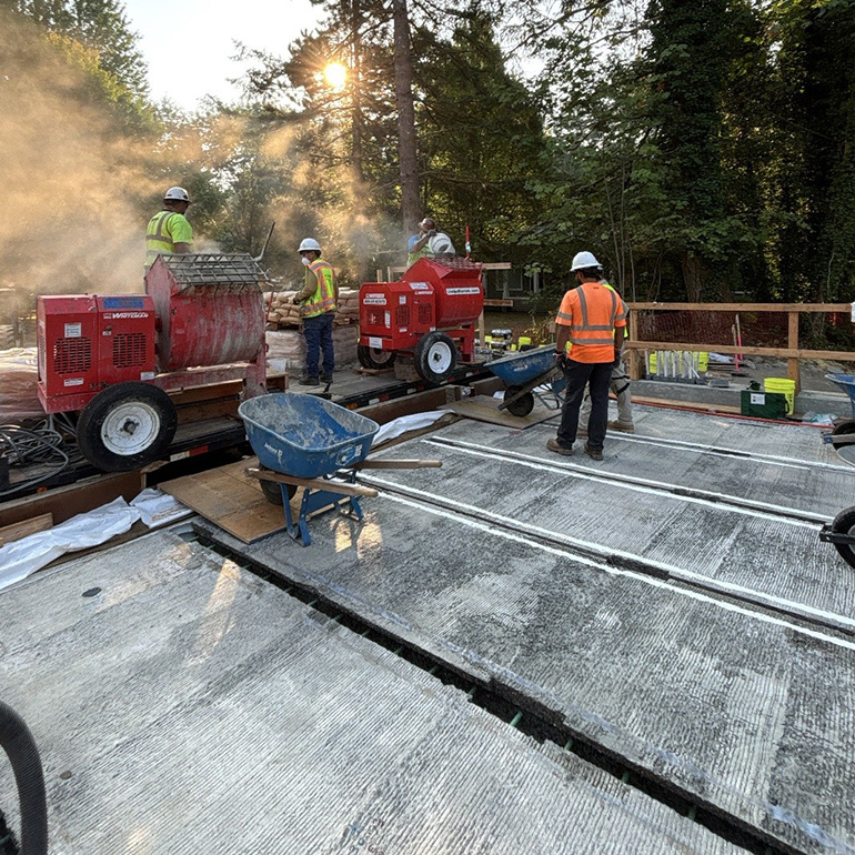 Crew members pouring new concrete.