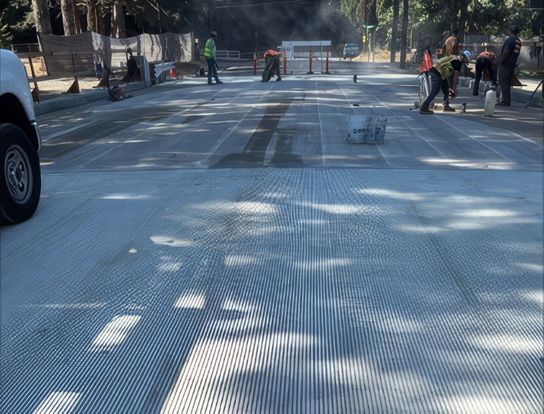 Crews working on bridge putting down polyester overlay