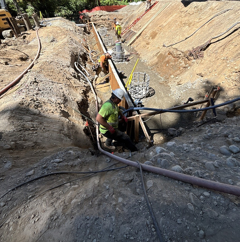 two workers in trench