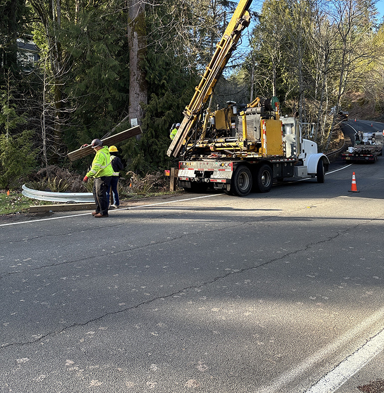 Contractor crews working on road with heavy machinery