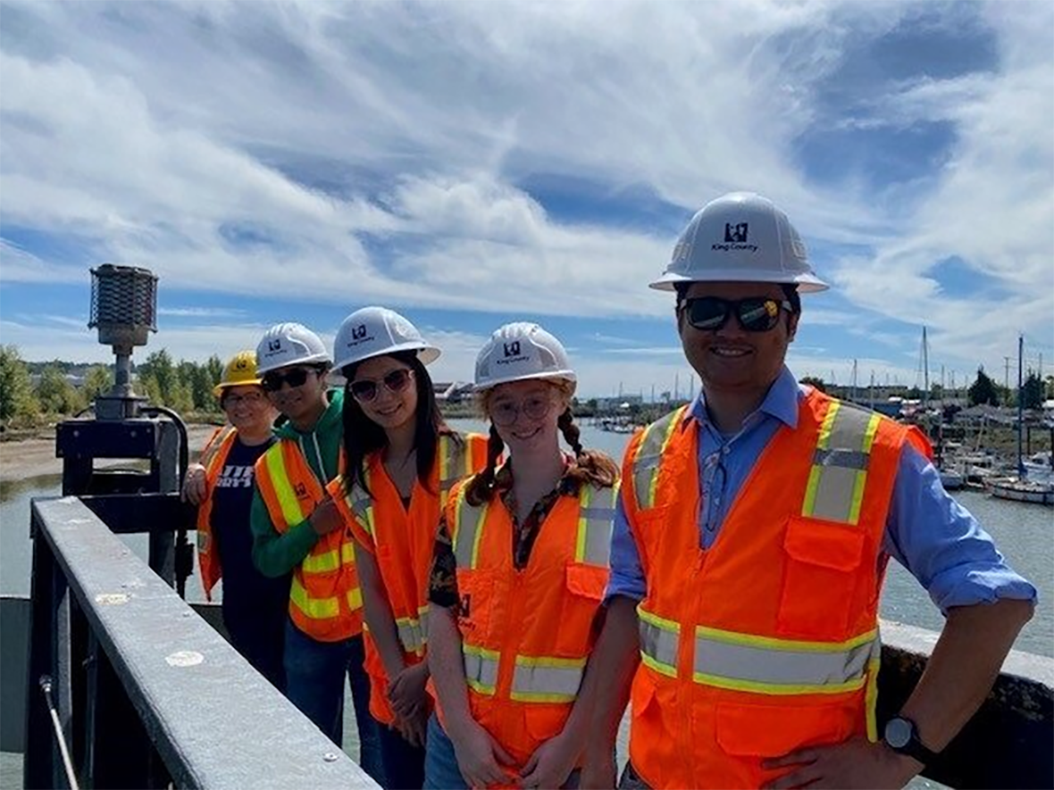 Interns at a tour of the South Park Bridge out on the bridge overlooking the Duwamish River.