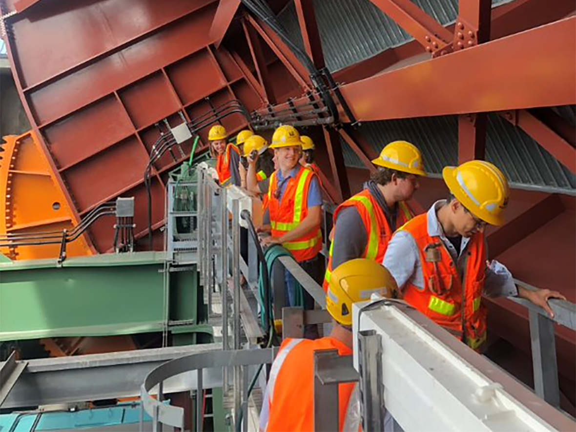 Interns inspecting the gears that open and close the South Park Bridge.