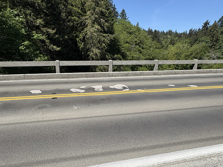 Road with patched potholes.