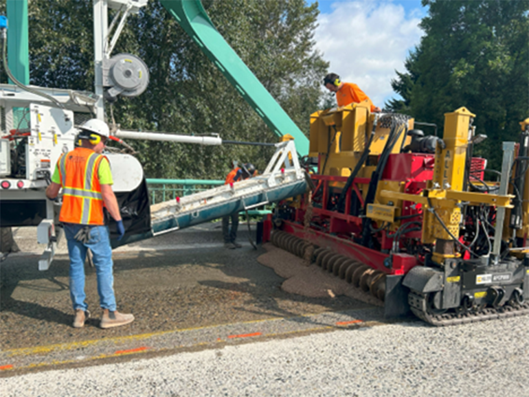 Contractor crews apply polyester polymer concrete on a bridge deck in Kent, WA. 