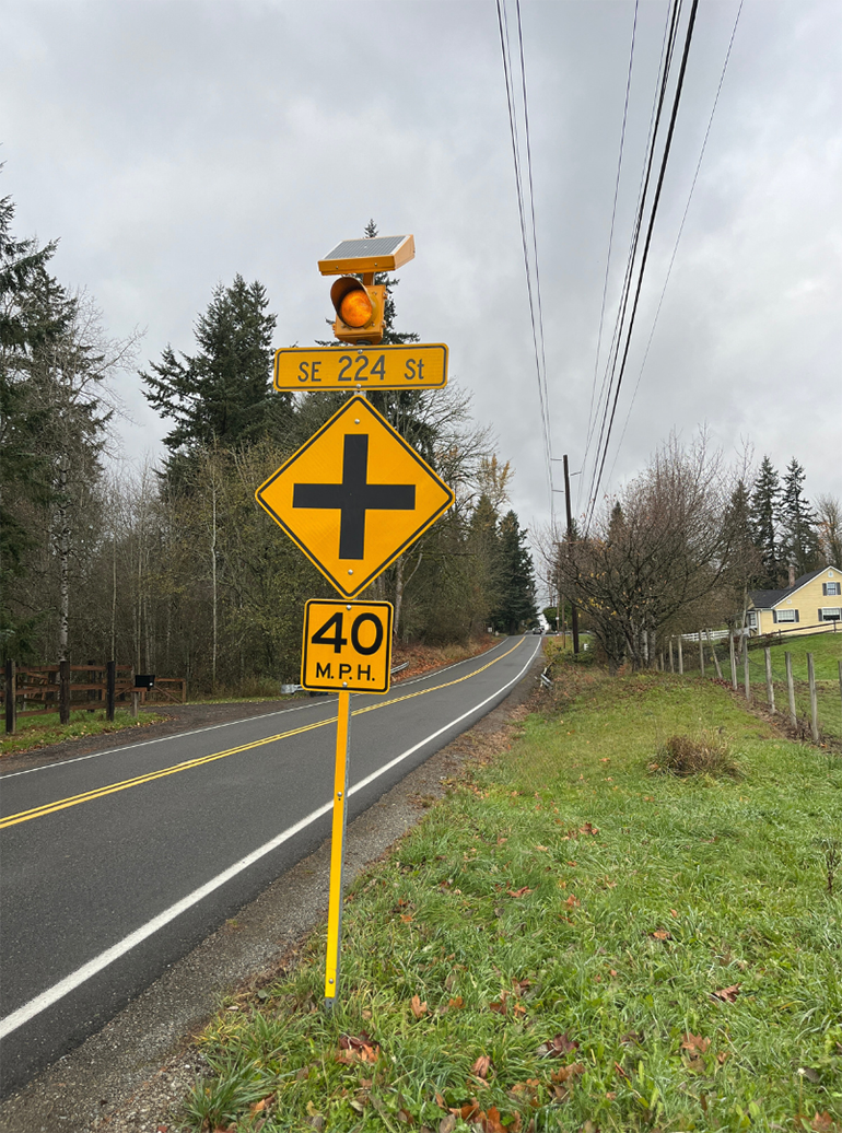 Advance warning sign with LED lights at the intersection of SE 224th St and 148th Avenue SE near Lake Youngs.
