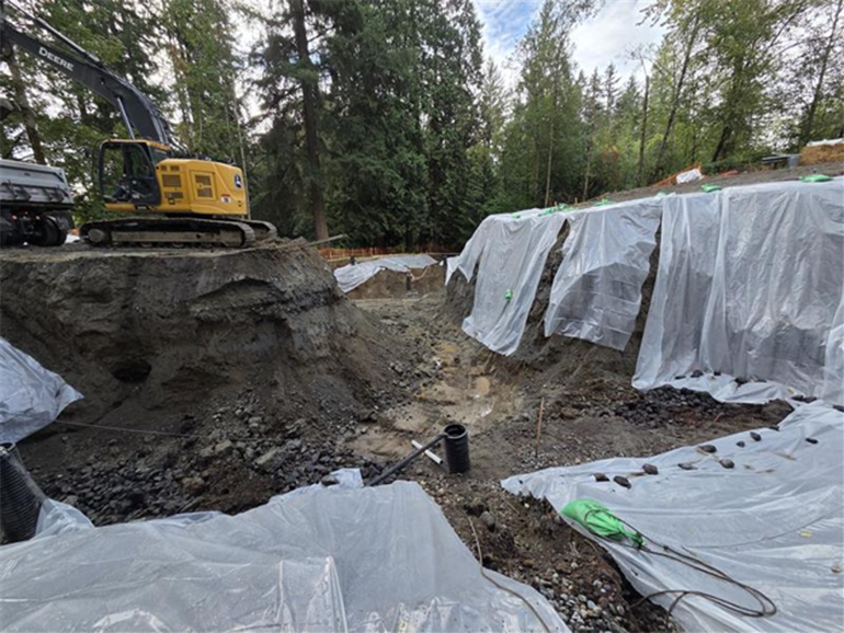 Heavy machinery and tarps on a worksite