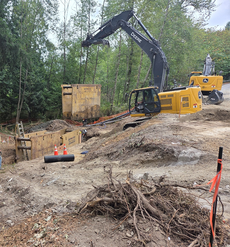 Crane carrying trench box