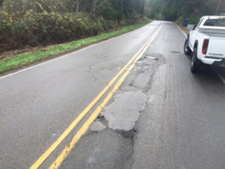 Photo from 2016 showing cracked road. Patching that was needed because the pipe is unstable and causes the road above it to shift.