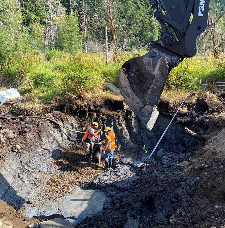 Two Crews are digging a deep pit in the earth .