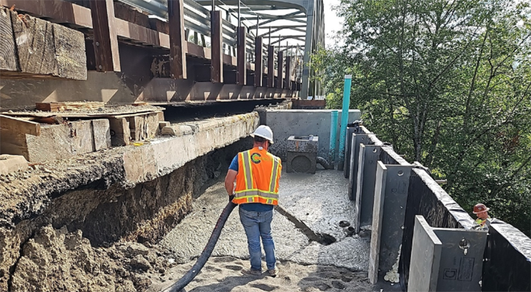 Crew member directs the lighweight concrete pour.