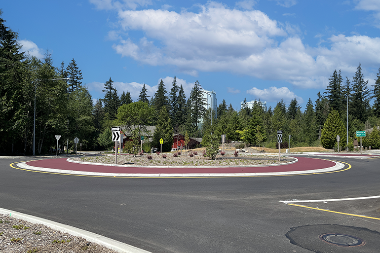 Completed roundabout with trees and blue sky.