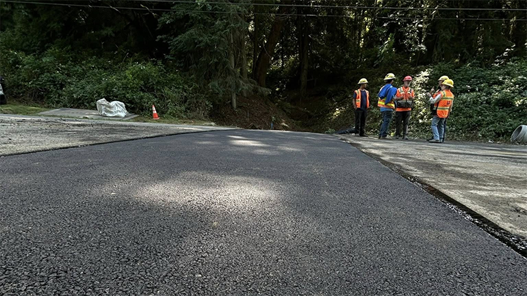 Work Crews standing next to completed roads project