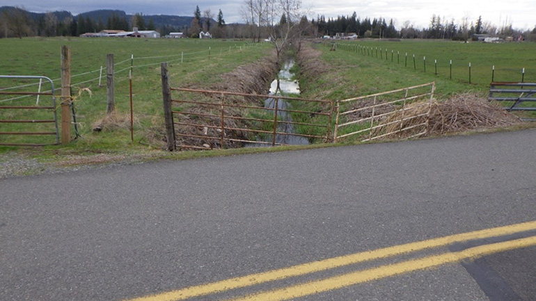 Metal pipe culvert under SE 472nd Street .