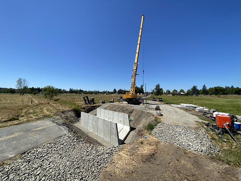 Crews used a large crane to place the bottom and sides of the new concrete box culvert.