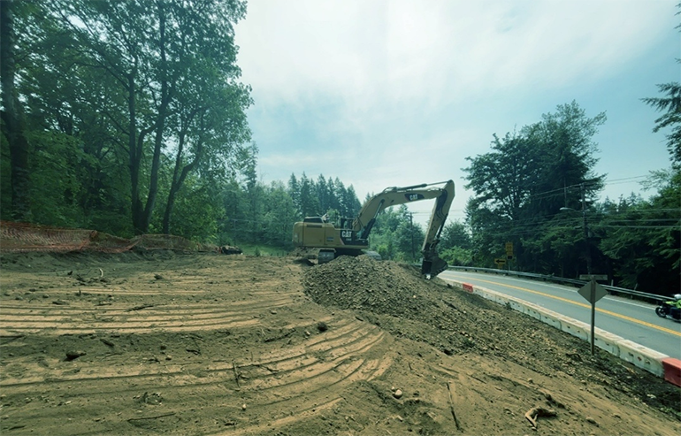 Cleared hillside alongside of road.
