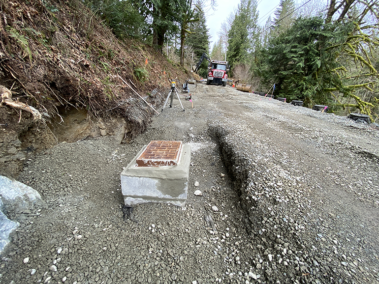 Gravel road with new concrete drainage system.