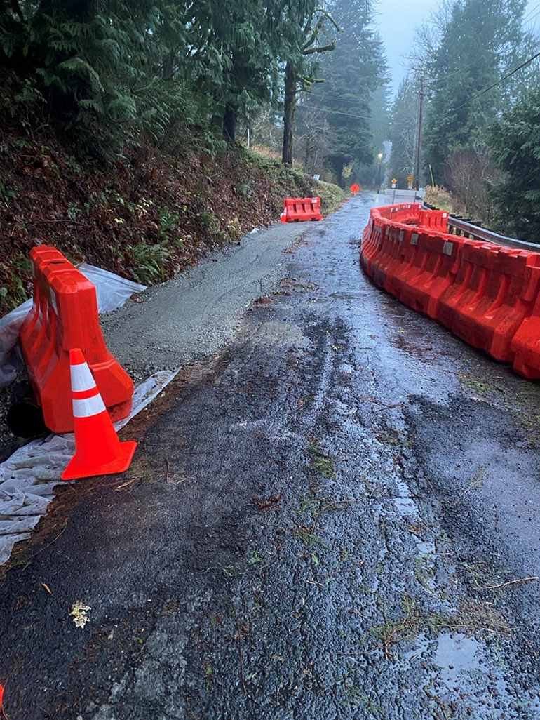 Ornage construction barriers and pillars along road
