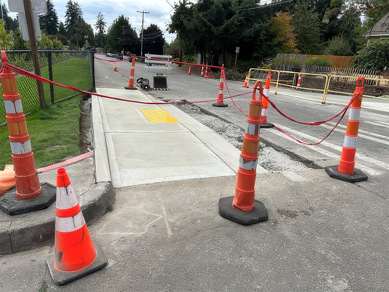 New ADA sidewalk surrounded by construction pillars